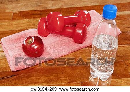 Water bottle with an apple and dumbbells View Large Photo Image Stock Photo - Water bottle with an apple and dumbbells. Fotosearch