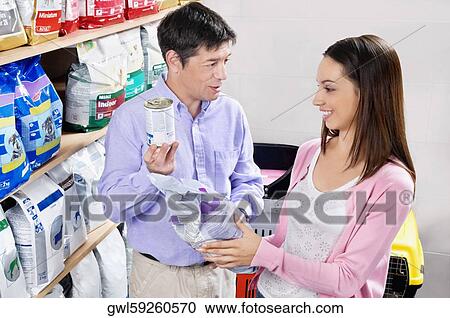 Woman and her father buying dog food in a supermarket View Large Photo Image Stock Image - Woman and her father buying dog food in a supermarket. Fotosearch