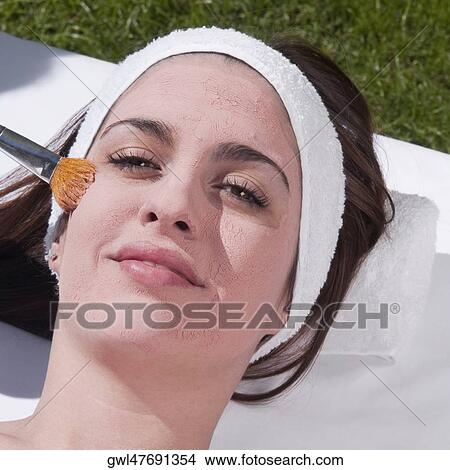 Woman applying a facial mask View Large Photo Image Picture - Woman applying a facial mask. Fotosearch