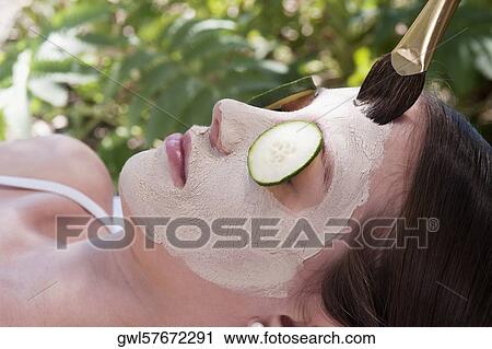 Woman applying a facial mask View Large Photo Image Stock Image - Woman applying a facial mask. Fotosearch