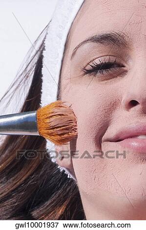 Woman applying a facial mask View Large Photo Image Stock Photo - Woman applying a facial mask. Fotosearch