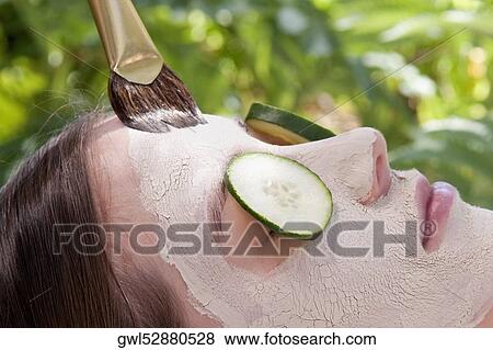 Woman applying a facial mask View Large Photo Image Stock Photo - Woman applying a facial mask. Fotosearch