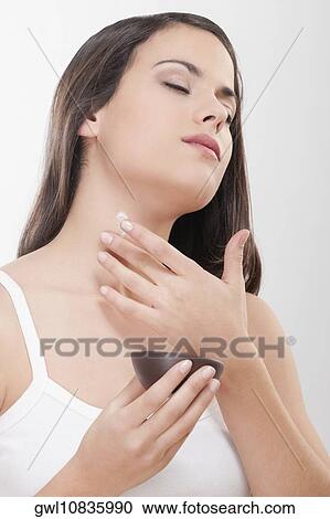 Woman applying moisturizer cream on her neck View Large Photo Image Stock Image - Woman applying moisturizer cream on her neck. Fotosearch