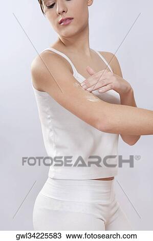 Woman applying moisturizer cream on her arm View Large Photo Image Stock Image - Woman applying moisturizer cream on her arm. Fotosearch
