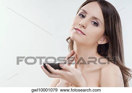 Woman applying moisturizer cream on her neck View Large Photo Image Stock Photo - Woman applying moisturizer cream on her neck. Fotosearch