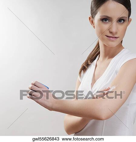 Woman applying moisturizer on her hand View Large Photo Image Stock Image - Woman applying moisturizer on her hand. Fotosearch