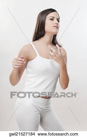 Picture - Woman applying perfume. Fotosearch