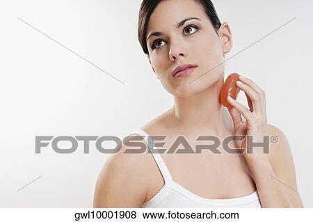 Woman applying soap on her neck View Large Photo Image Stock Photo - Woman applying soap on her neck. Fotosearch