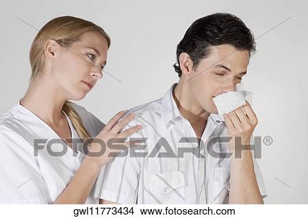 Woman beside a man suffering from cold View Large Photo Image Picture - Woman beside a man suffering from cold. Fotosearch