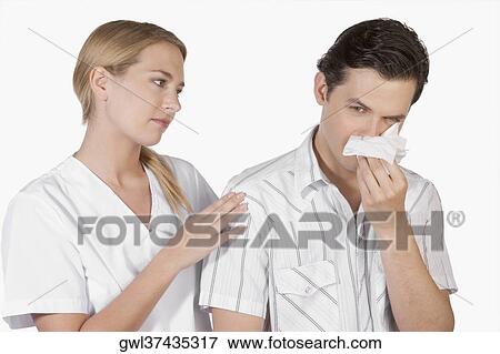 Woman beside a man suffering from cold View Large Photo Image Stock Photo - Woman beside a man suffering from cold. Fotosearch