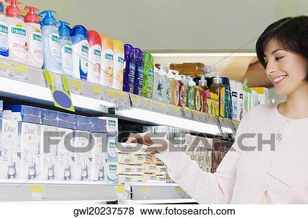 Woman buying cosmetics in a supermarket View Large Photo Image Stock Photo - Woman buying cosmetics in a supermarket. Fotosearch