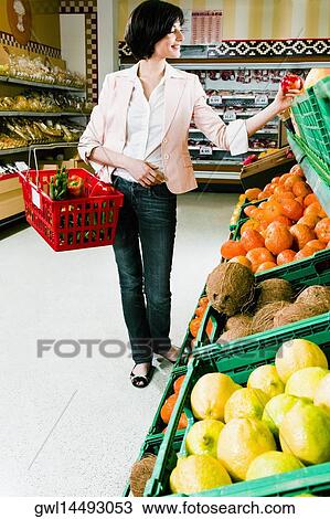 Woman buying fruits in a supermarket View Large Photo Image Stock Image - Woman buying fruits in a supermarket. Fotosearch