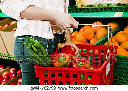 Woman buying fruits in a supermarket View Large Photo Image Stock Photo - Woman buying fruits in a supermarket. Fotosearch