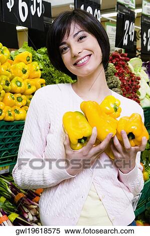Woman buying yellow peppers in a supermarket View Large Photo Image Stock Photography - Woman buying yellow peppers in a supermarket. Fotosearch