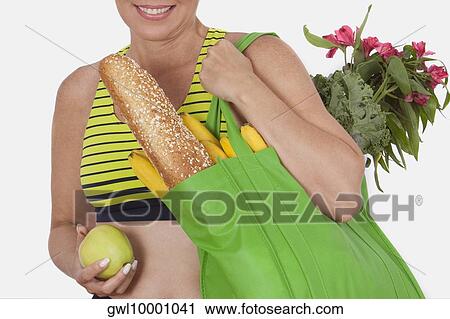 Woman carrying a bag of groceries View Large Photo Image Stock Image - Woman carrying a bag of groceries. Fotosearch
