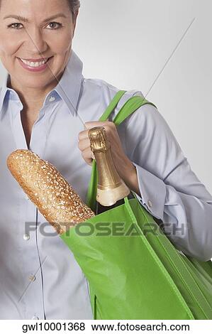 Woman carrying a bag of groceries View Large Photo Image Stock Photo - Woman carrying a bag of groceries. Fotosearch