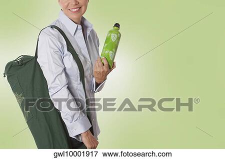 Stock Photo - Woman carrying a bag. Fotosearch