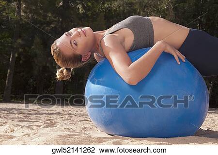 Woman doing exercise with fitness ball on the beach View Large Photo Image Stock Image - Woman doing exercise with fitness ball on the beach. Fotosearch