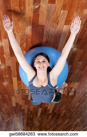Woman doing sit-ups on a fitness ball View Large Photo Image Stock Image - Woman doing sit-ups on a fitness ball. Fotosearch