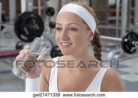 Woman drinking water and smiling View Large Photo Image Stock Photo - Woman drinking water and smiling. Fotosearch