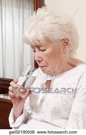 Woman drinking water View Large Photo Image Stock Photo - Woman drinking water. Fotosearch