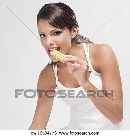 Woman eating a wafer snack View Large Photo Image Stock Image - Woman eating a wafer snack. Fotosearch
