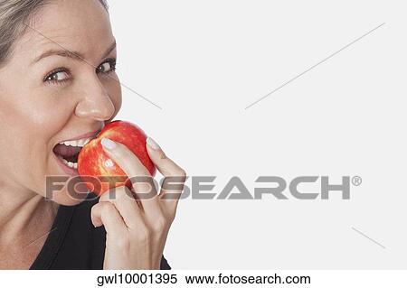 Woman eating an apple View Large Photo Image Stock Photography - Woman eating an apple. Fotosearch
