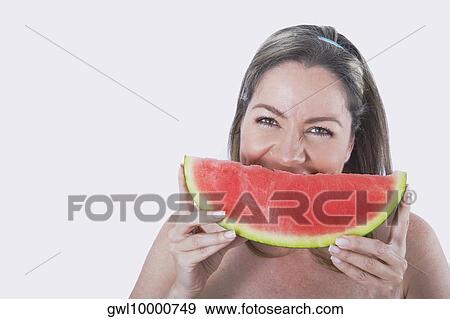 Woman eating watermelon View Large Photo Image Stock Photo - Woman eating watermelon. Fotosearch