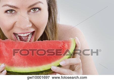 Stock Photo - Woman eating watermelon. Fotosearch