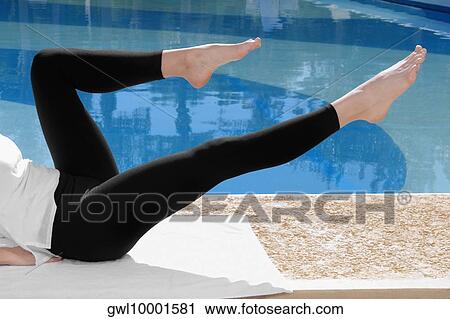 Woman exercising at the poolside View Large Photo Image Stock Image - Woman exercising at the poolside. Fotosearch