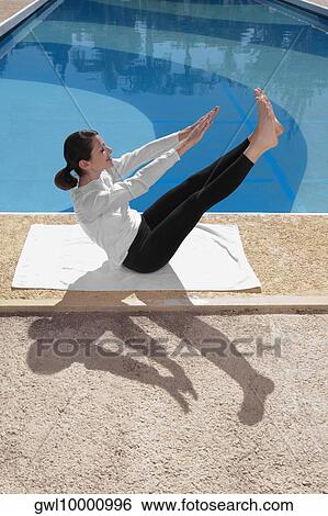 Woman exercising at the poolside View Large Photo Image Stock Photograph - Woman exercising at the poolside. Fotosearch