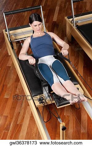 Woman exercising in a gym View Large Photo Image Stock Image - Woman exercising in a gym. Fotosearch