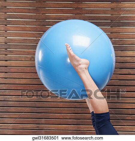 Woman exercising with a fitness ball View Large Photo Image Stock Image - Woman exercising with a fitness ball. Fotosearch