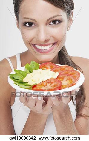 Woman holding a basil with tomato and cheese platter View Large Photo Image Stock Image - Woman holding a basil with tomato and cheese platter. Fotosearch