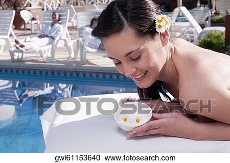 Woman holding a bowl of flowers View Large Photo Image Stock Image - Woman holding a bowl of flowers. Fotosearch
