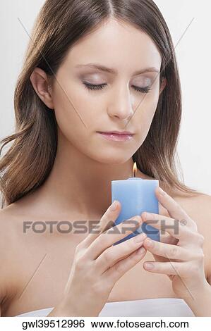 Stock Photograph - Woman holding a candle. Fotosearch