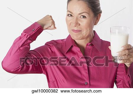 Woman holding a glass of milk View Large Photo Image Stock Image - Woman holding a glass of milk. Fotosearch