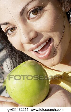 Woman holding a granny smith apple View Large Photo Image Stock Photography - Woman holding a granny smith apple. Fotosearch