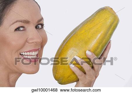 Woman holding a papaya View Large Photo Image Stock Photo - Woman holding a papaya. Fotosearch
