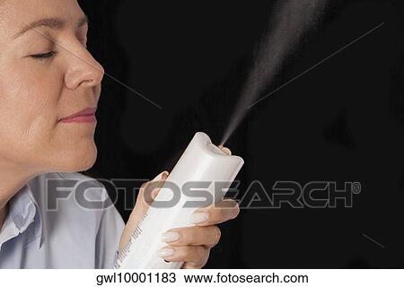 Woman holding a perfume sprayer View Large Photo Image Stock Image - Woman holding a perfume sprayer. Fotosearch