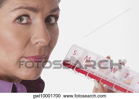 Woman holding a pill box View Large Photo Image Stock Image - Woman holding a pill box. Fotosearch