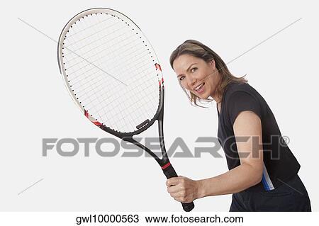 Woman holding a tennis racket and smiling View Large Photo Image Stock Image - Woman holding a tennis racket and smiling. Fotosearch