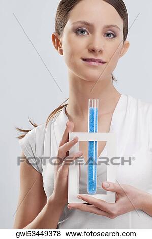 Woman holding a test tube of bath crystals View Large Photo Image Stock Photo - Woman holding a test tube of bath crystals. Fotosearch