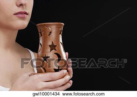 Woman holding an incense burner View Large Photo Image Picture - Woman holding an incense burner. Fotosearch