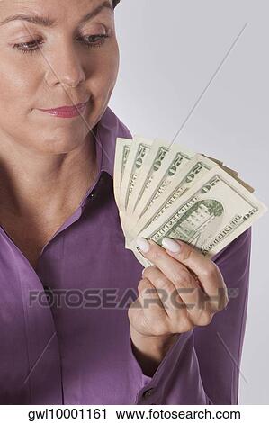 Woman holding currency notes View Large Photo Image Stock Image - Woman holding currency notes. Fotosearch