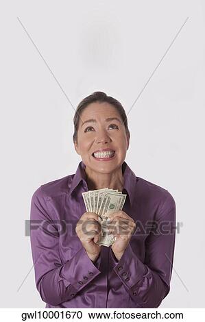 Woman holding currency notes View Large Photo Image Stock Image - Woman holding currency notes. Fotosearch