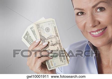 Woman holding currency notes View Large Photo Image Stock Image - Woman holding currency notes. Fotosearch
