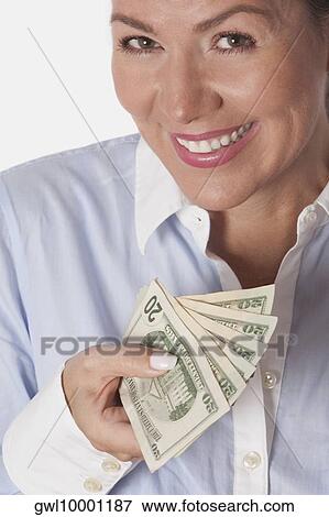 Stock Photo - Woman holding currency notes. Fotosearch