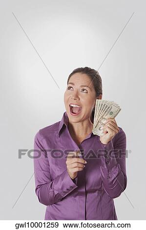 Woman holding currency notes View Large Photo Image Stock Photo - Woman holding currency notes. Fotosearch