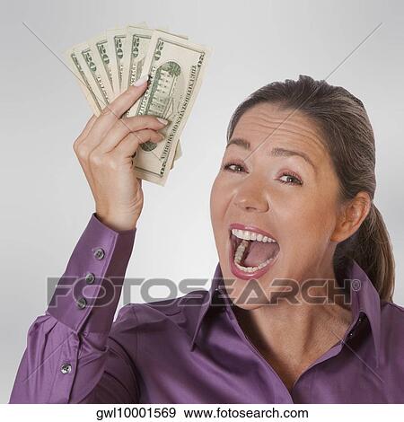 Woman holding currency notes View Large Photo Image Stock Photo - Woman holding currency notes. Fotosearch